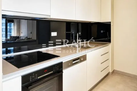 Modern kitchen with built-in appliances and a black backsplash. - image 5