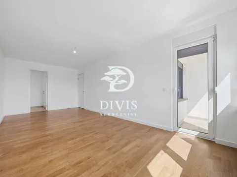 Empty room with wooden flooring and access to a balcony. - image 3