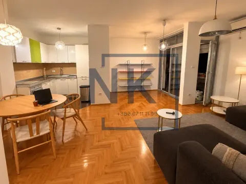 Spacious living room with a dining area and an open kitchen. - image 2