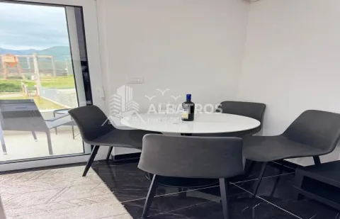 Dining table with four chairs and a view of the terrace. - image 4