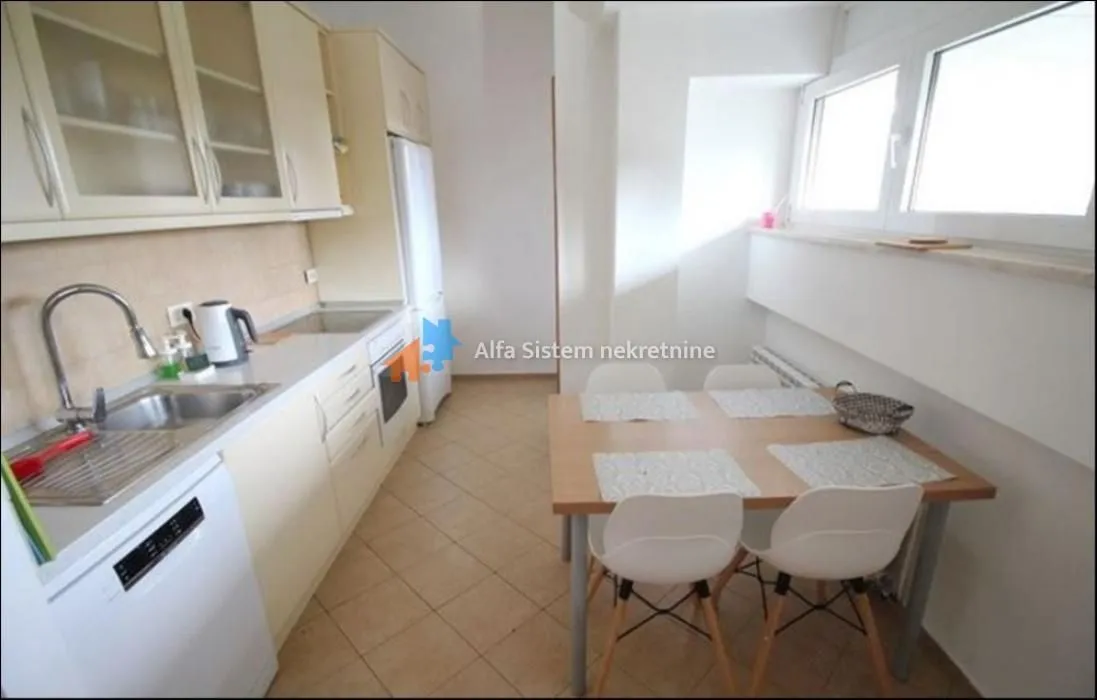 Kitchen with a dining table and chairs by the window.