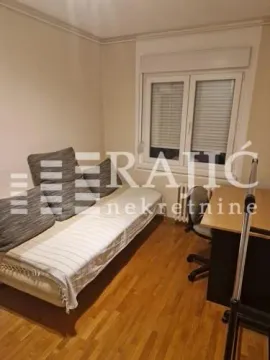 Small bedroom with a bed and a desk. - image 9