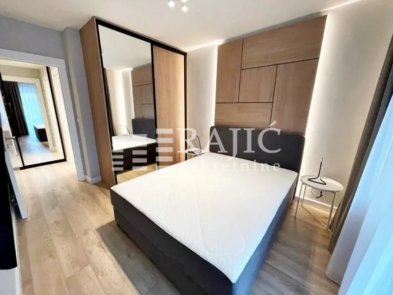 Modern bedroom with a double bed and a large fitted wardrobe.