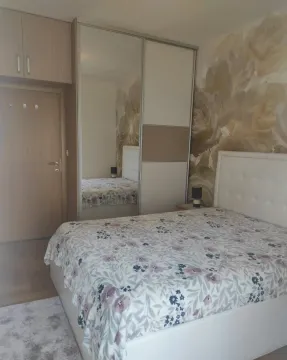 Bedroom with a double bed, fitted wardrobe, and floral wallpaper. - image 4