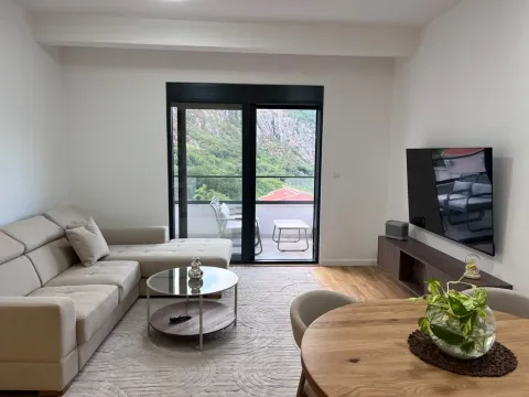 Bright living room with a sofa, dining table, and access to the terrace. - image 3