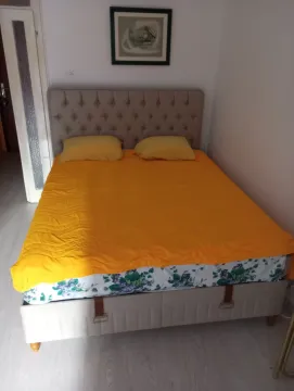 Bedroom with a double bed and orange bedding. - image 6