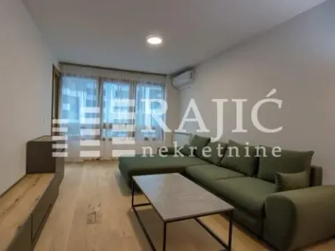 Living room with a sofa and coffee table. - image 3