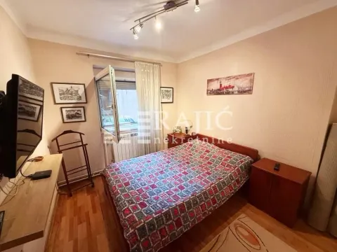 Furnished bedroom with a double bed, TV, and access to the terrace. - image 4