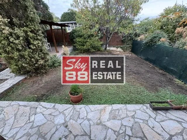View of the private courtyard with greenery and a paved area.