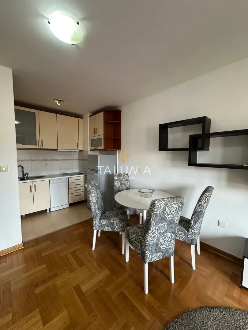 Dining area with a table and chairs connected to the kitchen.