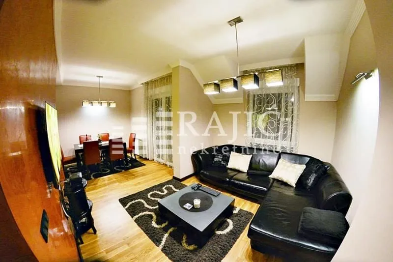 Spacious living room with sofa set and dining area.