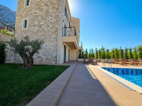 View of the building exterior with a swimming pool and landscaped yard. - image 20