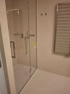 Modernly equipped bathroom with a walk-in shower. - image 8
