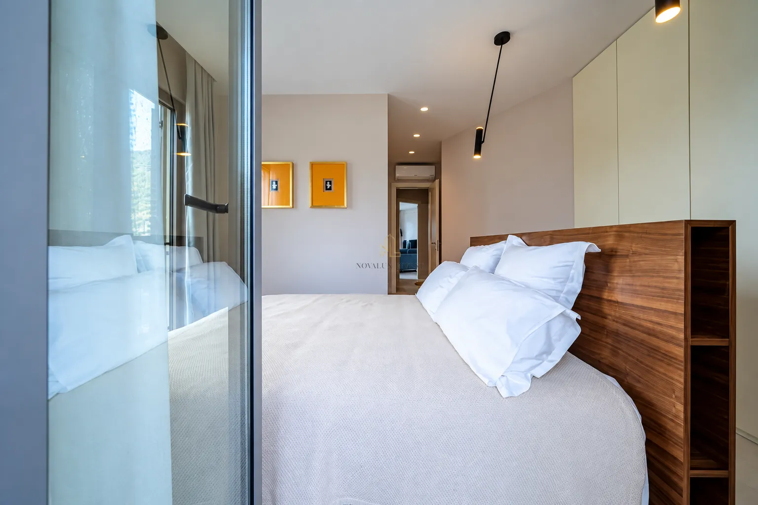 Modern bedroom with a double bed and built-in wardrobe.