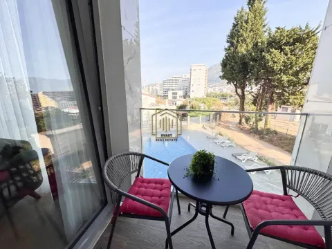 Balcony with outdoor seating and a view of the pool and surroundings. - image 13