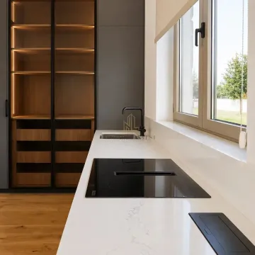 Modern kitchen with a built-in cooktop and light-colored cabinets. - image 4