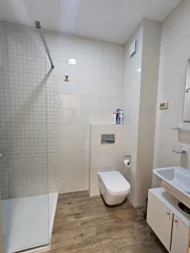 Modernly equipped bathroom with a shower cabin and white sanitary ware. - image 8