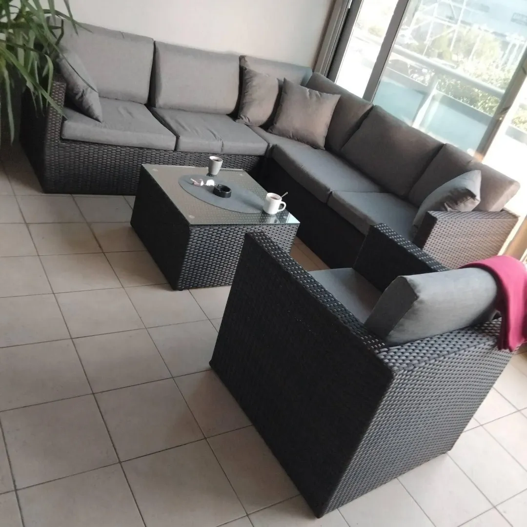 Furnished covered terrace with seating set.