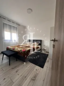 A view of a furnished bedroom with a double bed and a window. - image 28