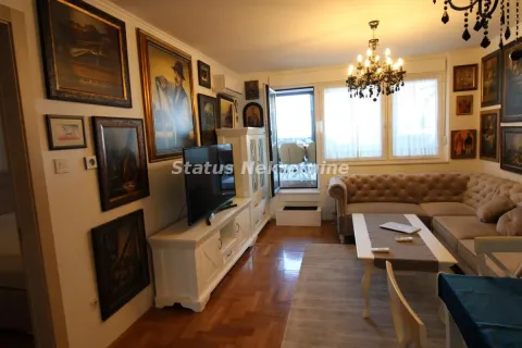Living room with sofa, TV, and artwork on the walls. - image 5