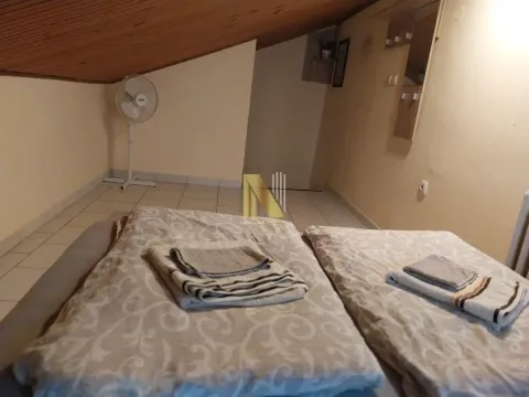 Potkrovna spavaća soba sa krevetom i ventilatorom. - image 9